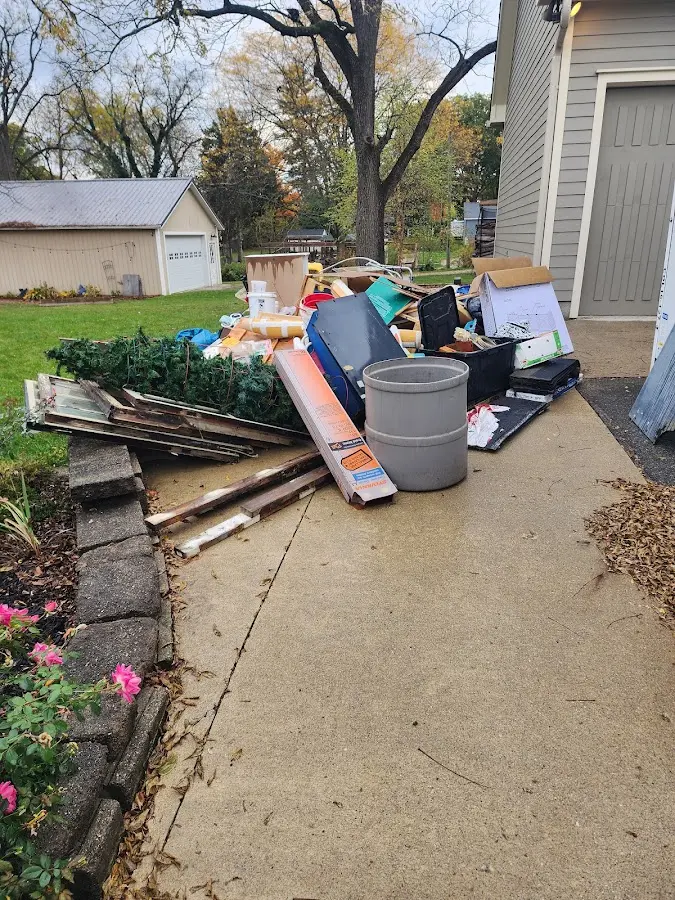 Dumpster being loaded with debris for 12 Yard Dumpster Rental in Kennewick